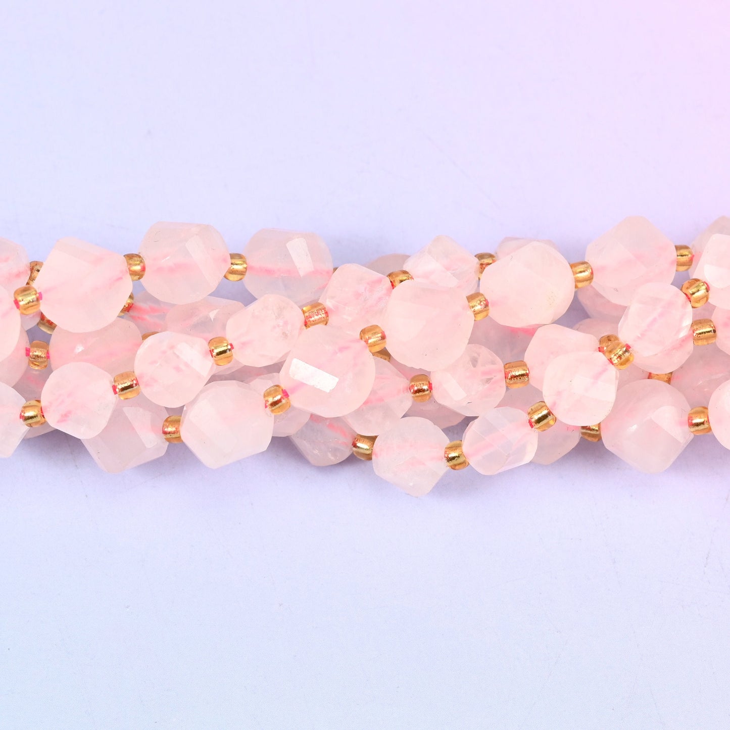 Natural Rose Quartz with slim gold-tone discs between beads