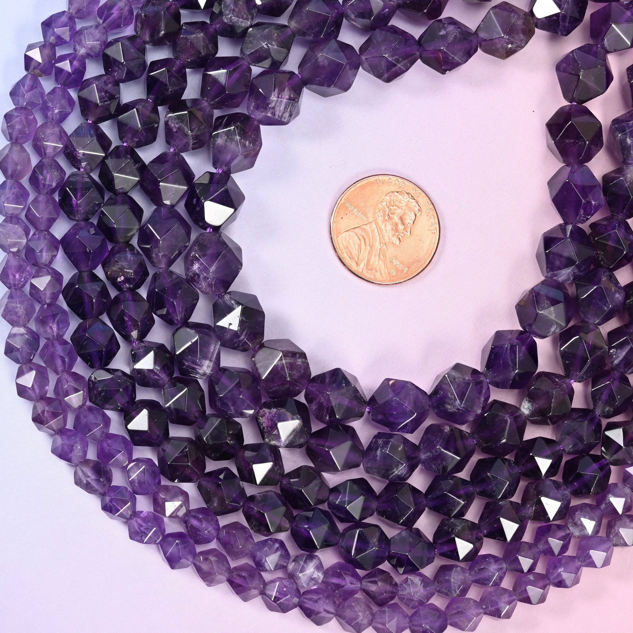 Amethyst beads, approximately 38 to 63 per strand.