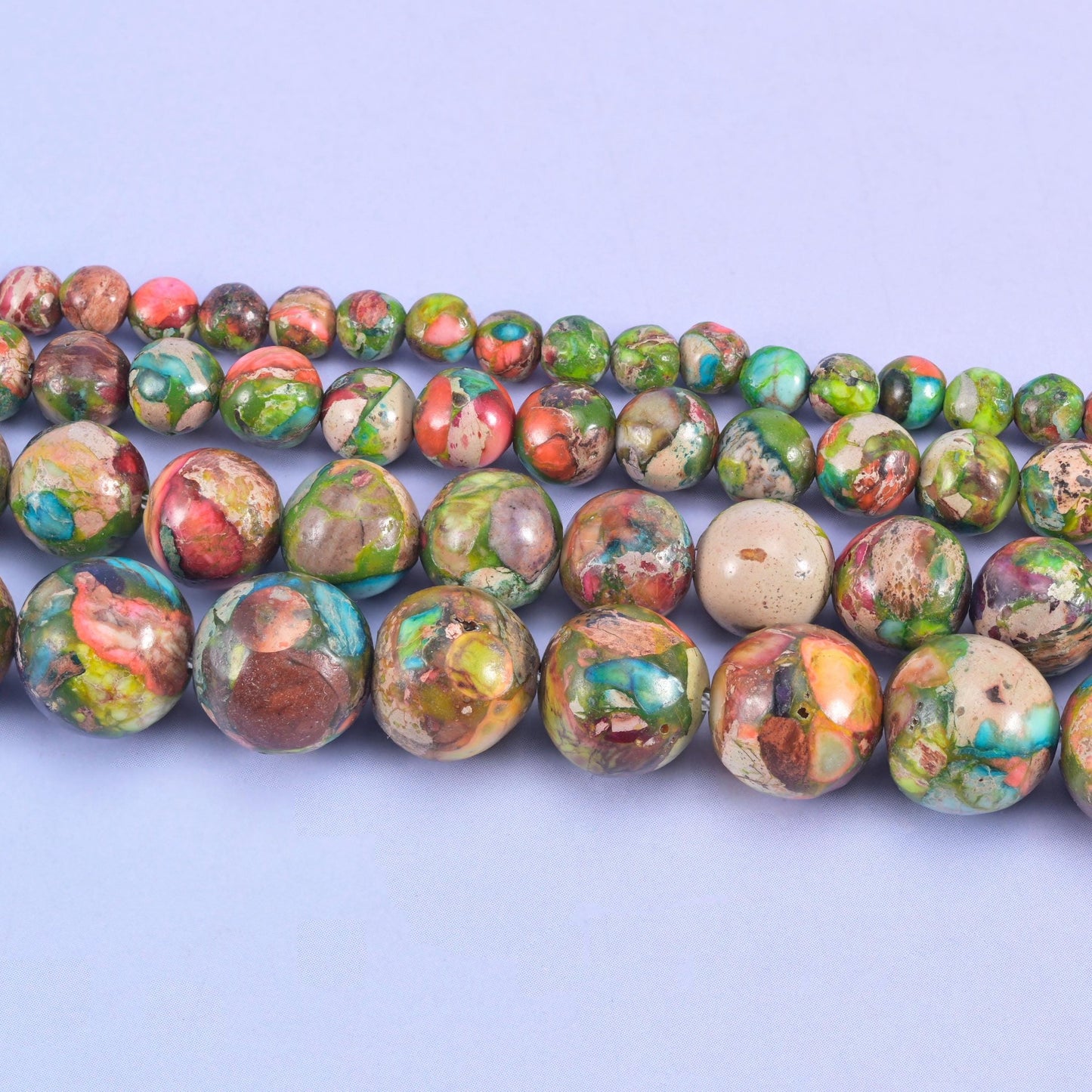 Dyed sea sediment jasper beads in turquoise, brick red, olive green, plum, and tan