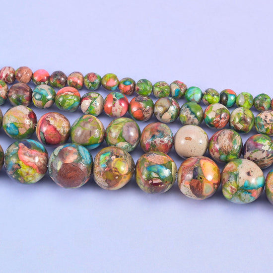 Dyed sea sediment jasper beads in turquoise, brick red, olive green, plum, and tan