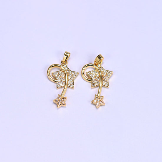 Two 18K gold plated wishing star zirconia charms side by side, each with a pave star, swirling wire trail and small trailing star.