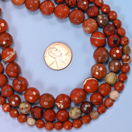 Group of flower red jasper round beads showing natural color and pattern variation.