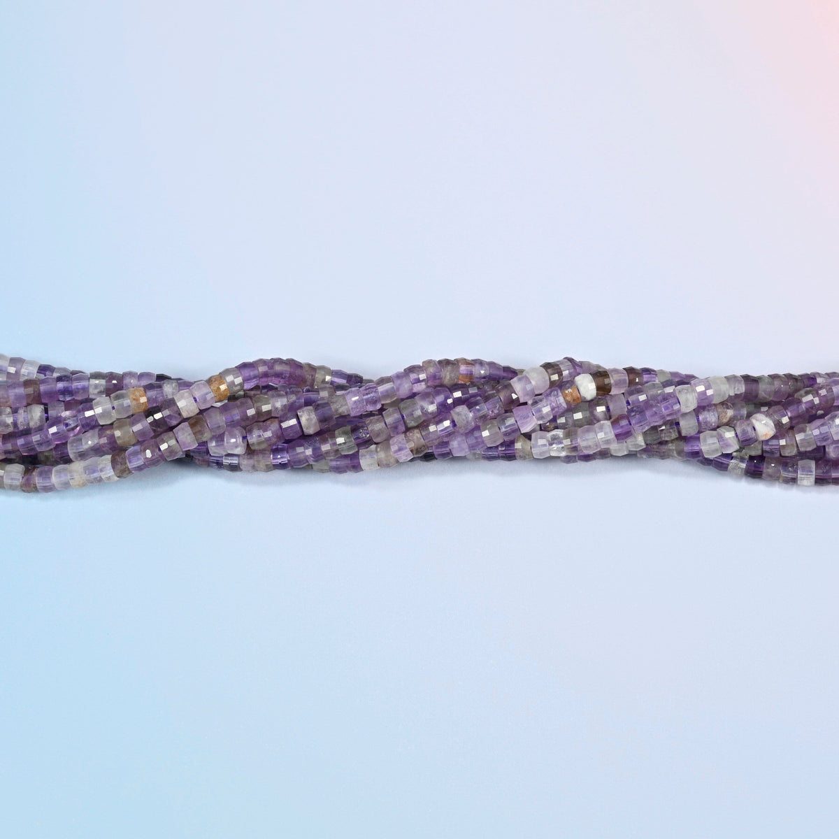 Strands of amethyst faceted heishi disc beads twisted together in a horizontal row