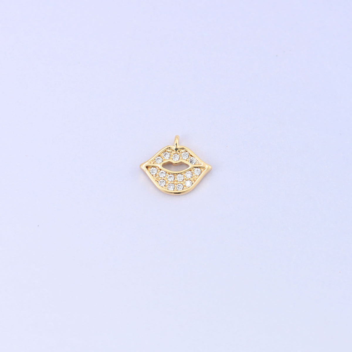 Small gold charms in a lip shape, 18K gold plated brass with clear cubic zirconia, single charm front view