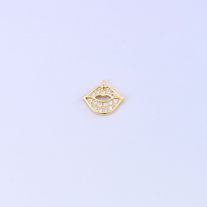 Small gold charms, a single 18K gold plated lip charm with clear cubic zirconia