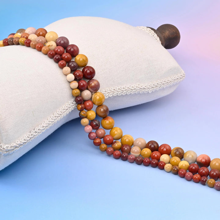 Mookaite Jasper Smooth Round Beads in mustard yellow, cream, brick red and deep maroon.