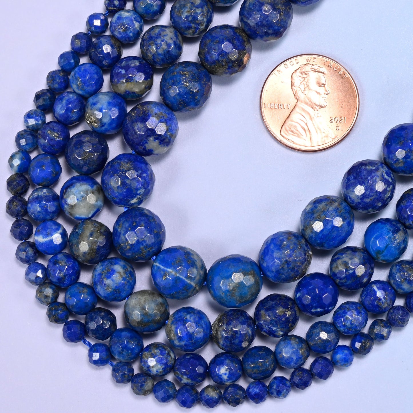Faceted round cut natural lapis lazuli beads for DIY jewelry making.
