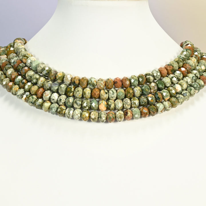 Snake skin jasper faceted rondelle strands arranged as a layered collar on a white display bust, green and brown tones across the neck
