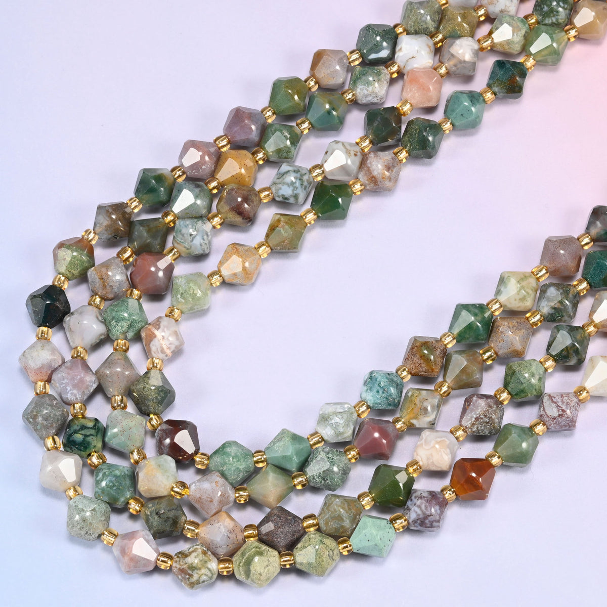 Indian Agate faceted bicone beads 8mm with gold-tone spacers, strand draped in a loose diagonal curve