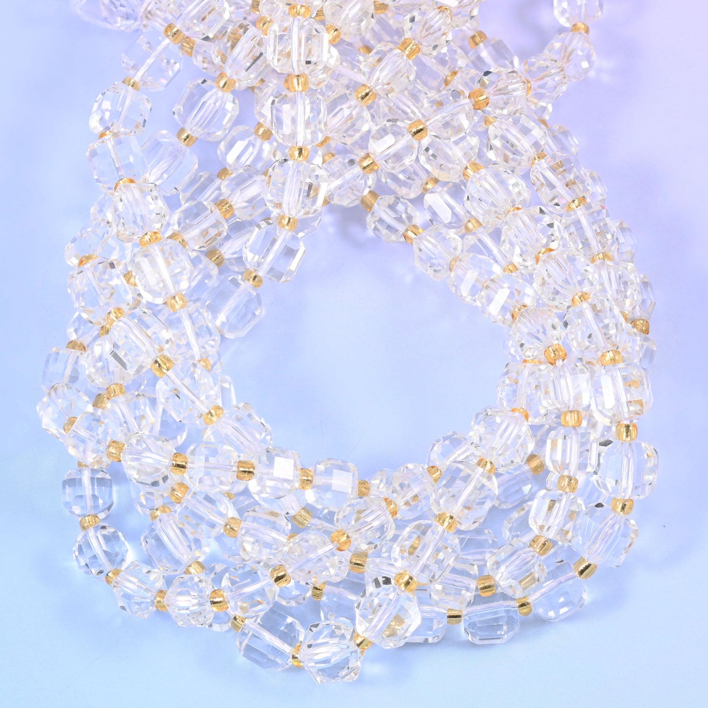 Colourless cubes with every edge and corner cut away into small facets, so light passes straight through the body and bounces back off the angles at the same time.