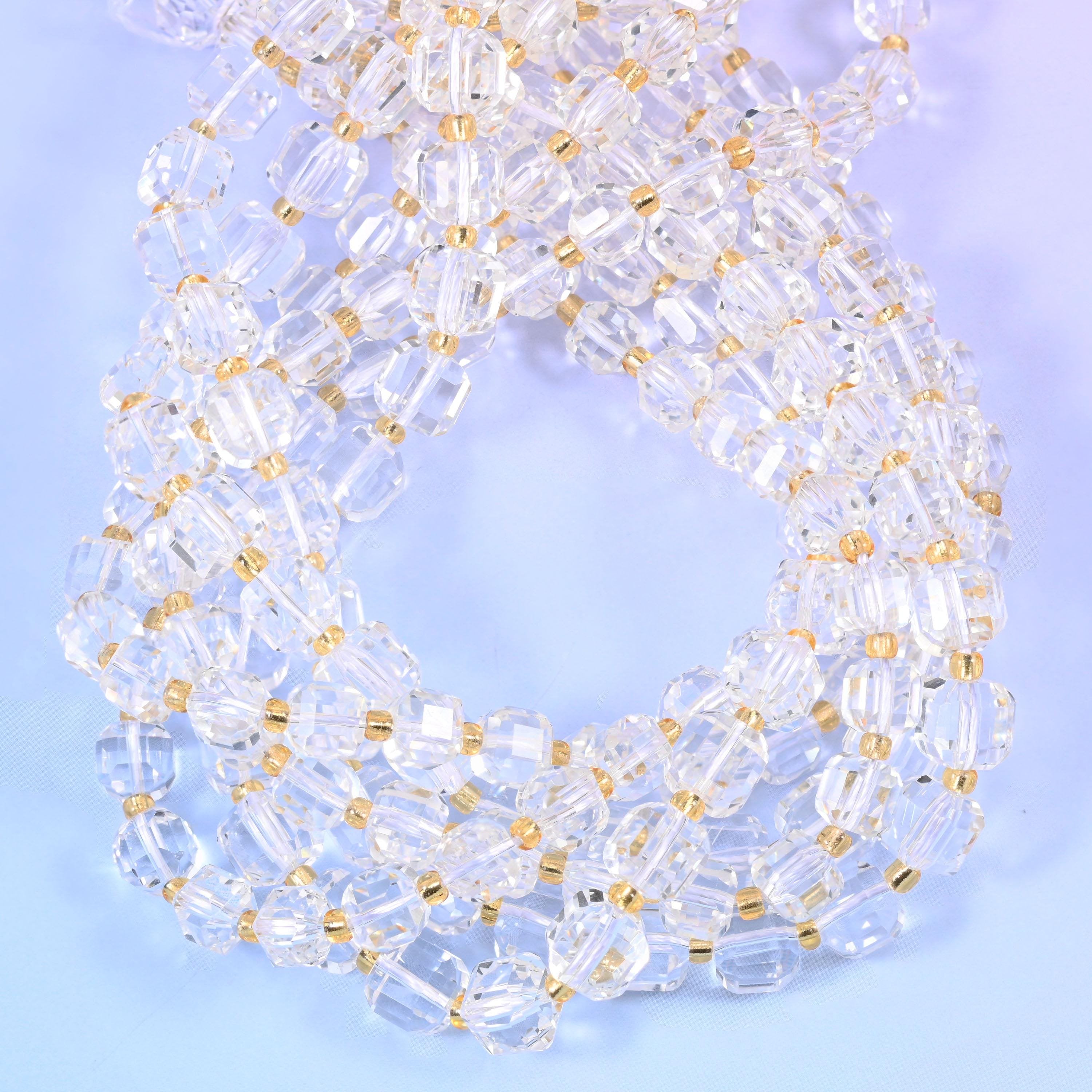 Colourless cubes with every edge and corner cut away into small facets, so light passes straight through the body and bounces back off the angles at the same time.