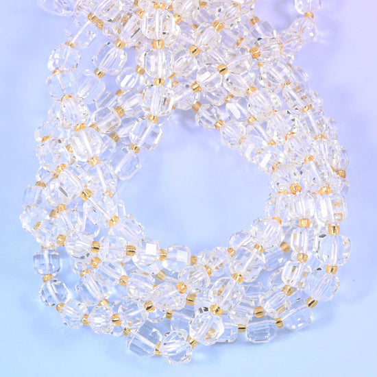 Colourless cubes with every edge and corner cut away into small facets, so light passes straight through the body and bounces back off the angles at the same time.