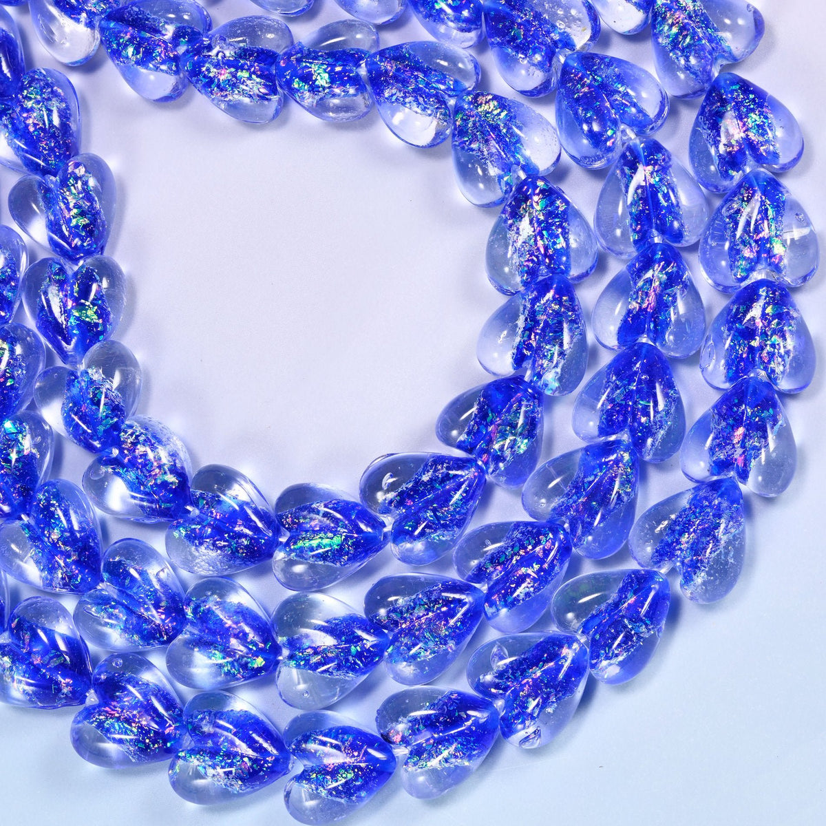 Transparent cobalt blue glass heart beads with iridescent glitter