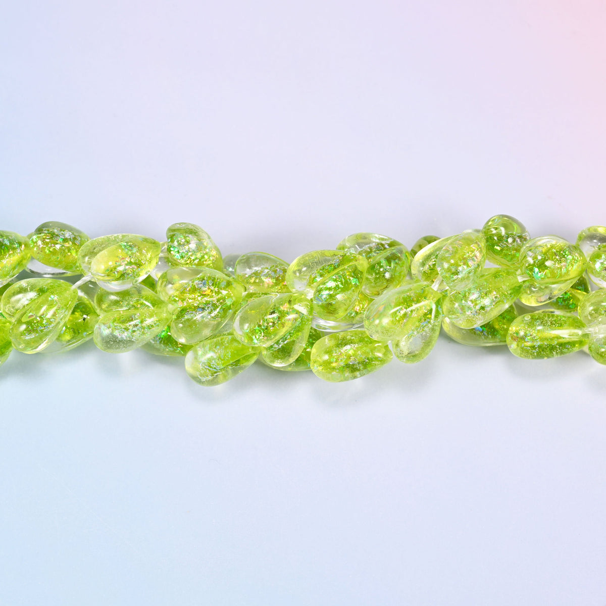 Clear glass hearts flooded with bright lime, plump at 8.54mm thick, with iridescent glitter suspended inside
