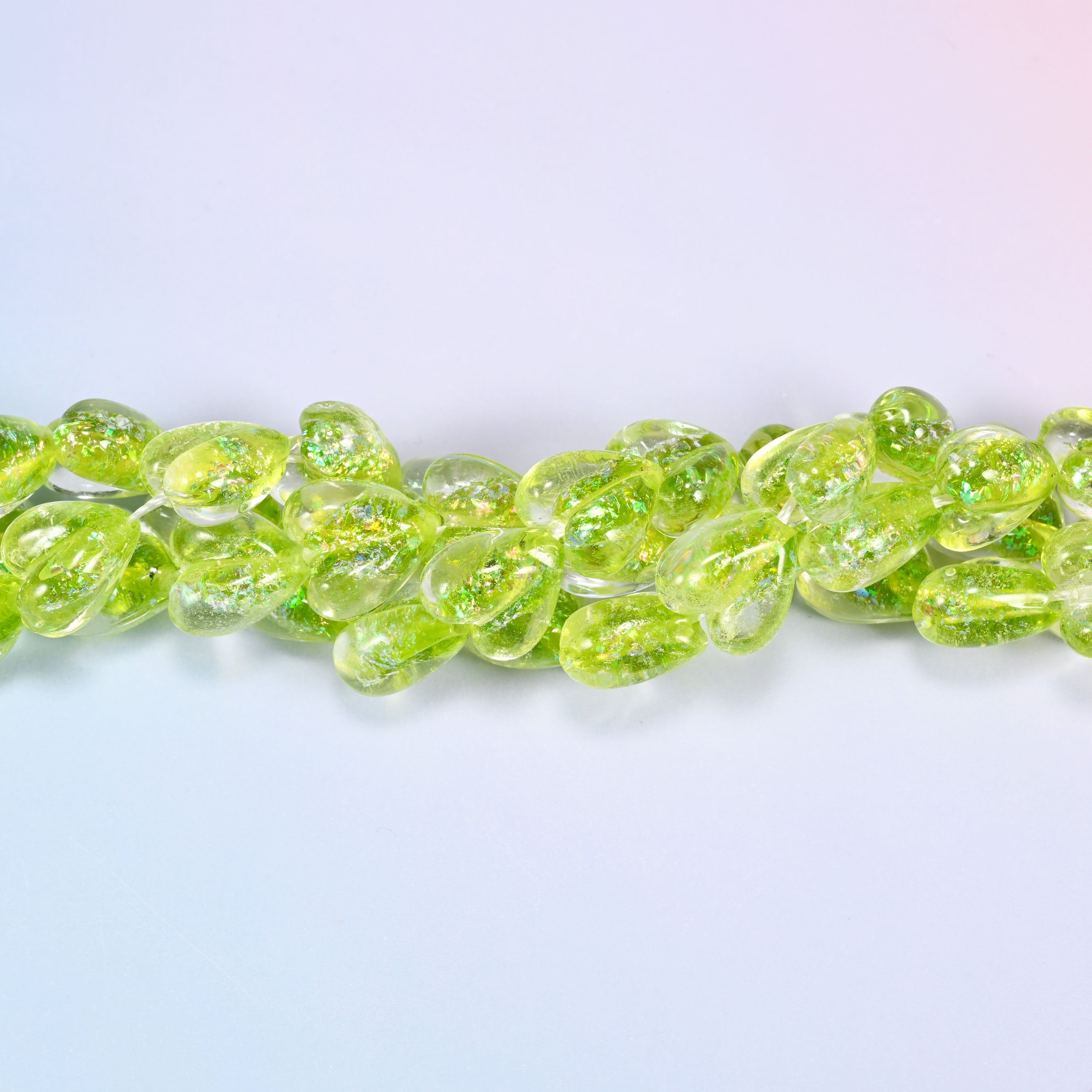 Clear glass hearts flooded with bright lime, plump at 8.54mm thick, with iridescent glitter suspended inside