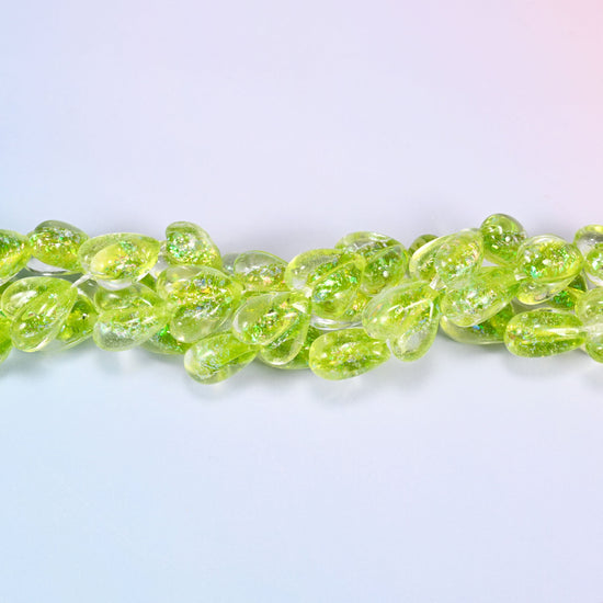 Clear glass hearts flooded with bright lime, plump at 8.54mm thick, with iridescent glitter suspended inside