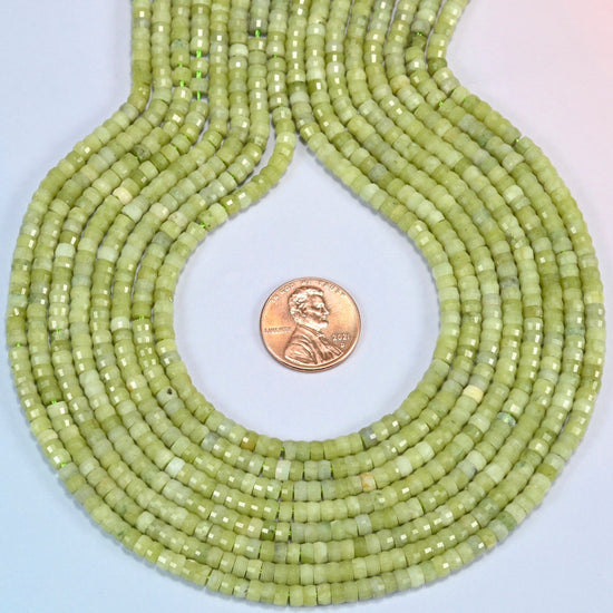 South Jade faceted heishi disc strands formed into a teardrop loop around a US penny for scale