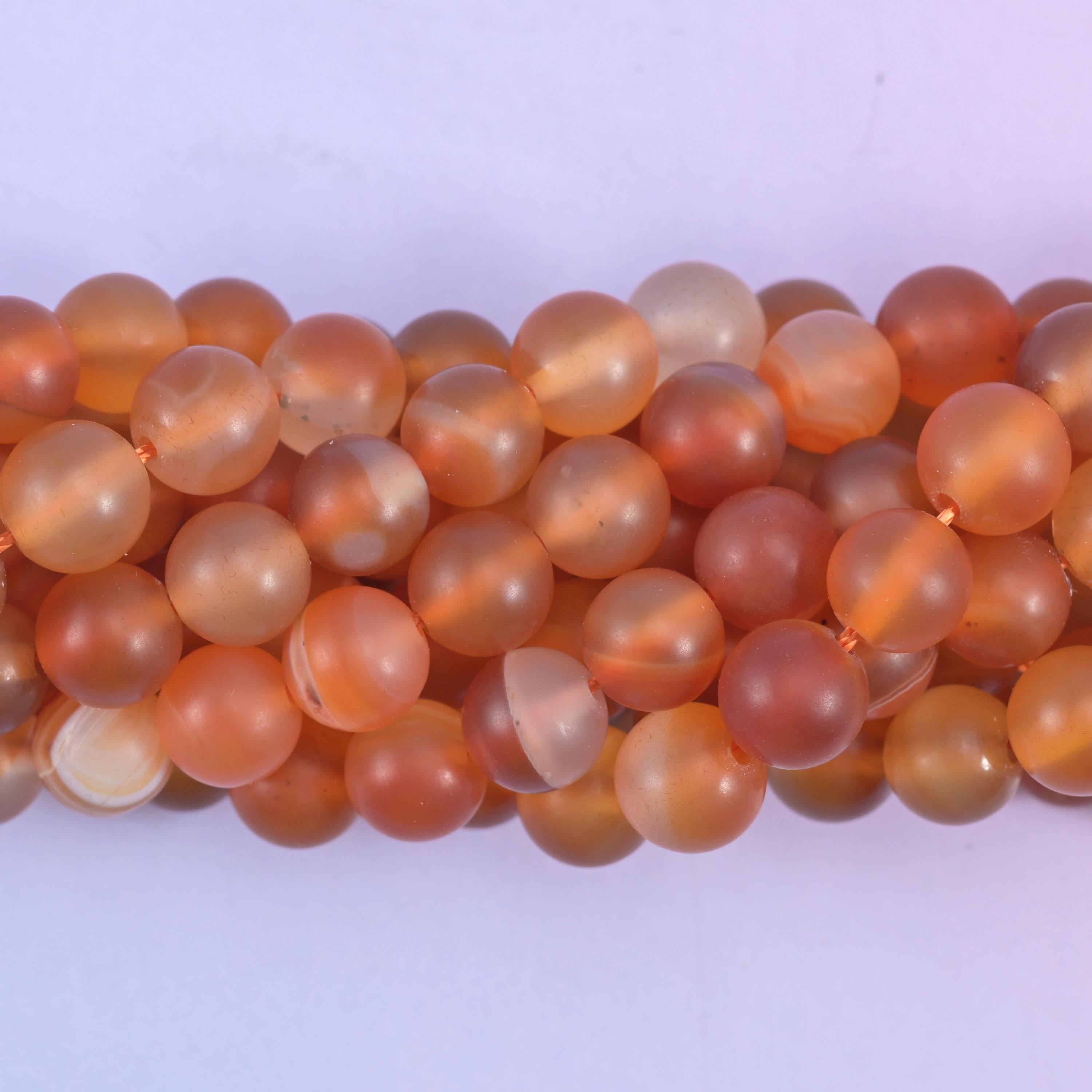 Round cut orange carnelian beads with a soft frosted matte surface