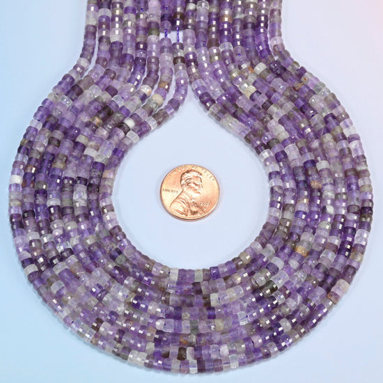 Amethyst faceted heishi disc strands formed into a teardrop loop around a US penny for scale