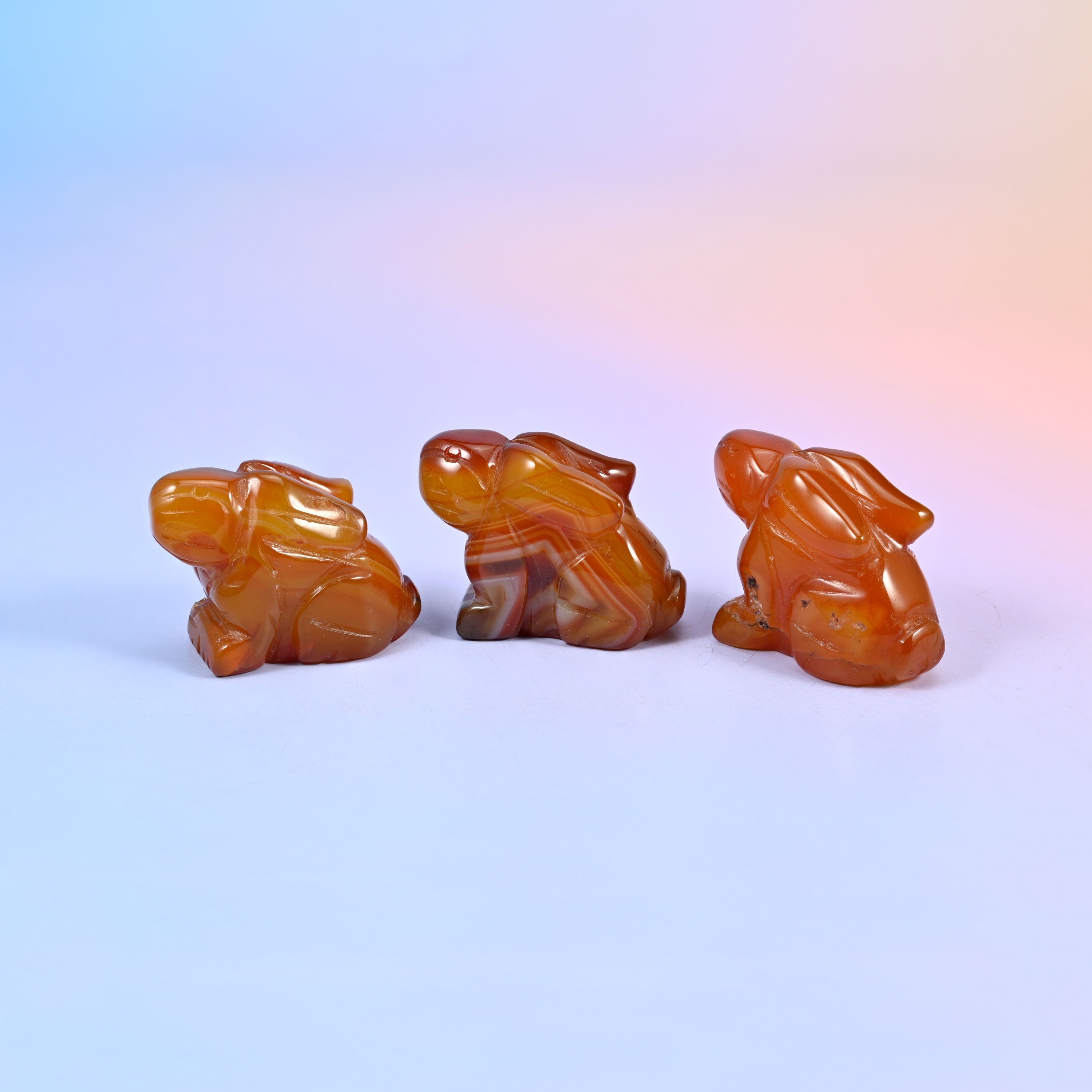 1.5 inch laying down bunny crystal figurine, carved with folded ears, tucked paws and a rounded tail