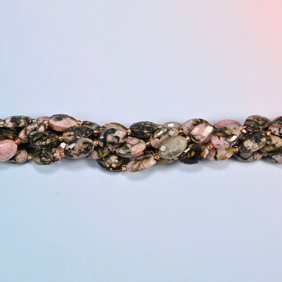 Strands of rhodonite faceted flat oval beads twisted together in a horizontal row