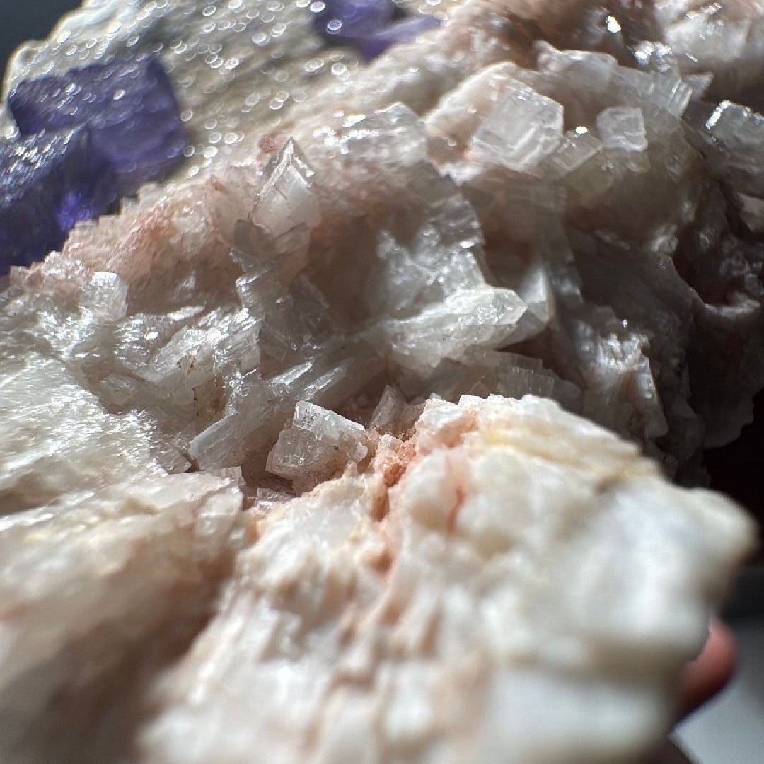 Detail of the bladed white quartz crystals fanning across the specimen face