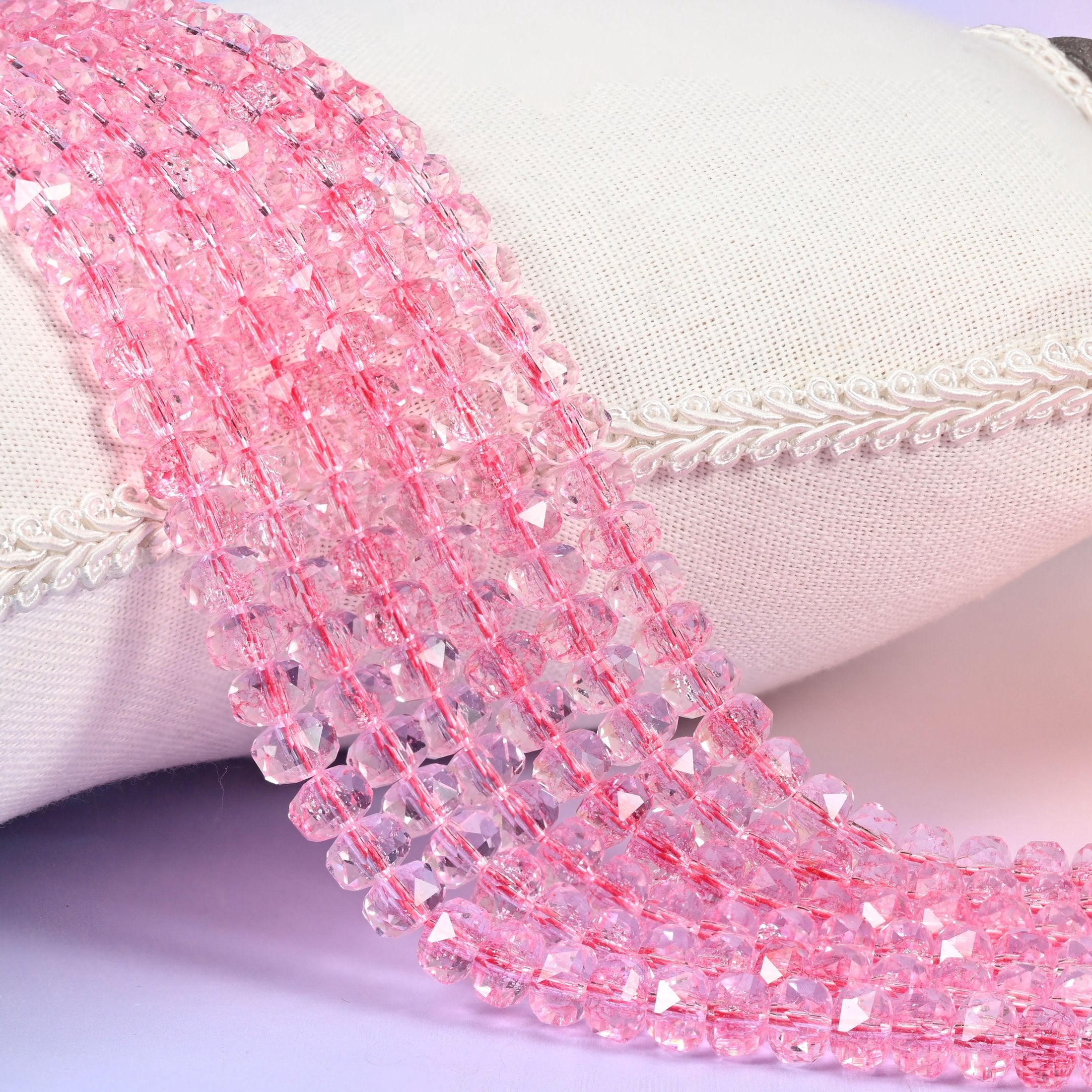 Transparent pink faceted rondelle glass beads, clear rose-pink with crisply cut facets