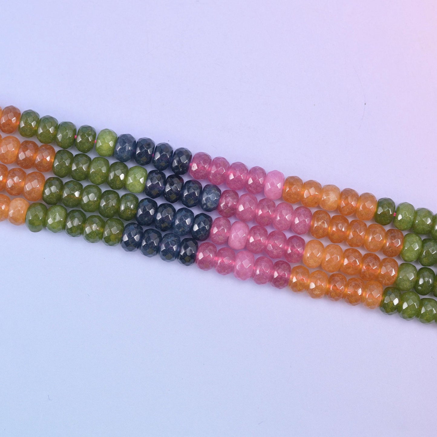 Tourmaline color dyed jade beads in blocked sections of olive green, warm apricot, rose pink and deep navy