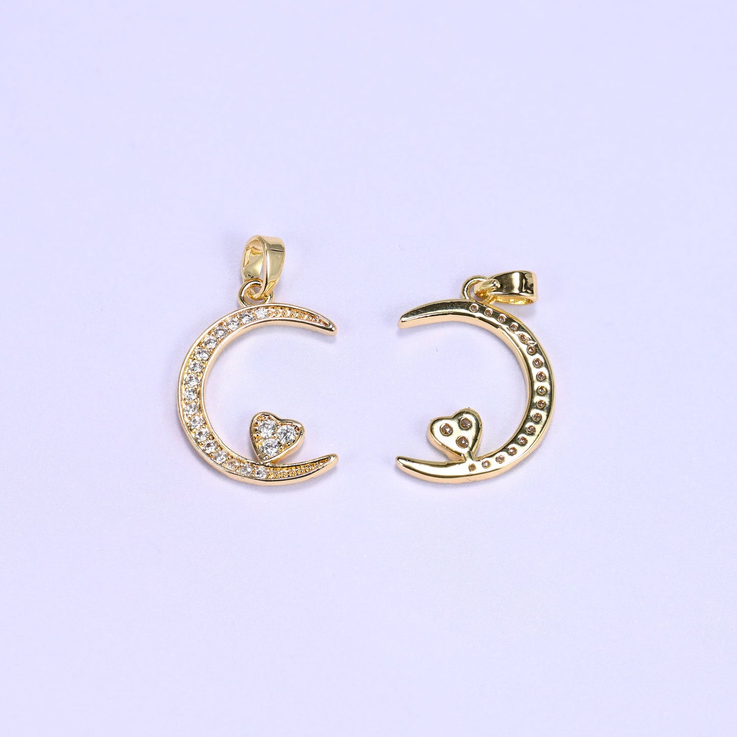 Gold moon heart zirconia charms front and back, one crescent pendant face up beside one flipped to the plain reverse.