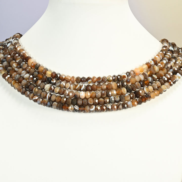 Dyed Brown Strip Agate gemstone rondelle beads 4x6mm shown on a white neck display as a layered necklace