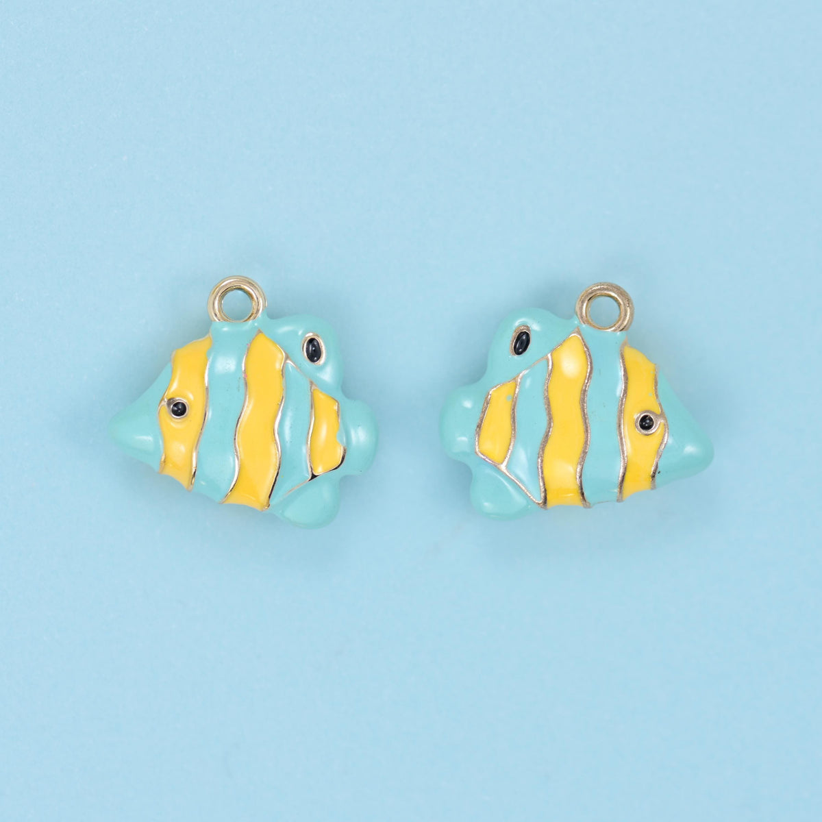 Enamel tropical fish charm in yellow and mint stripes, two charms side by side.