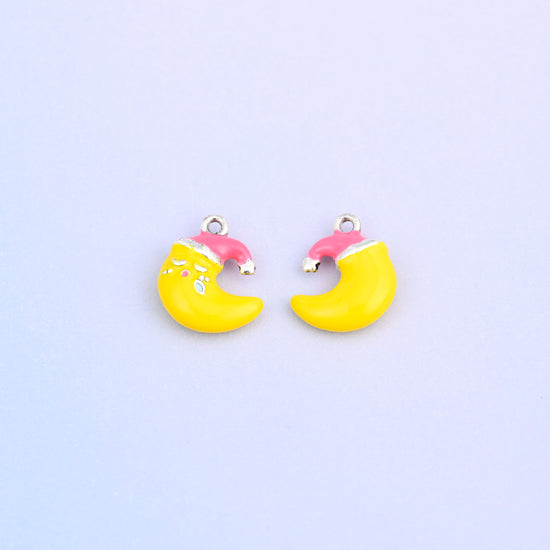 Yellow crescent moon charm in a pink Santa hat, front and back.