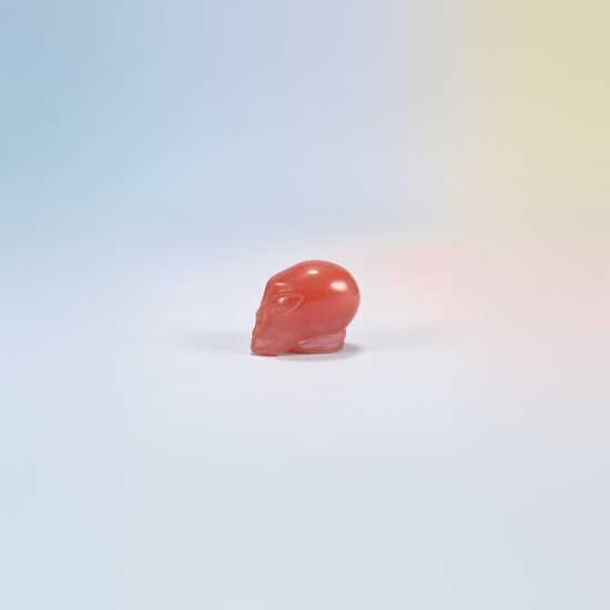 One cherry quartz alien head crystal carving, 1.5 inch, bright translucent pink-red man-made glass