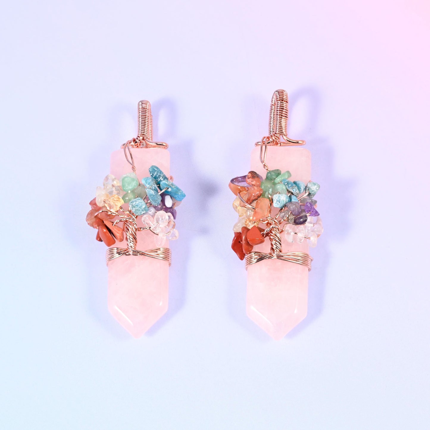 A polished single-point hexagon stone with a copper wire tree worked over the shoulder, set with small multi-colour gemstone chips