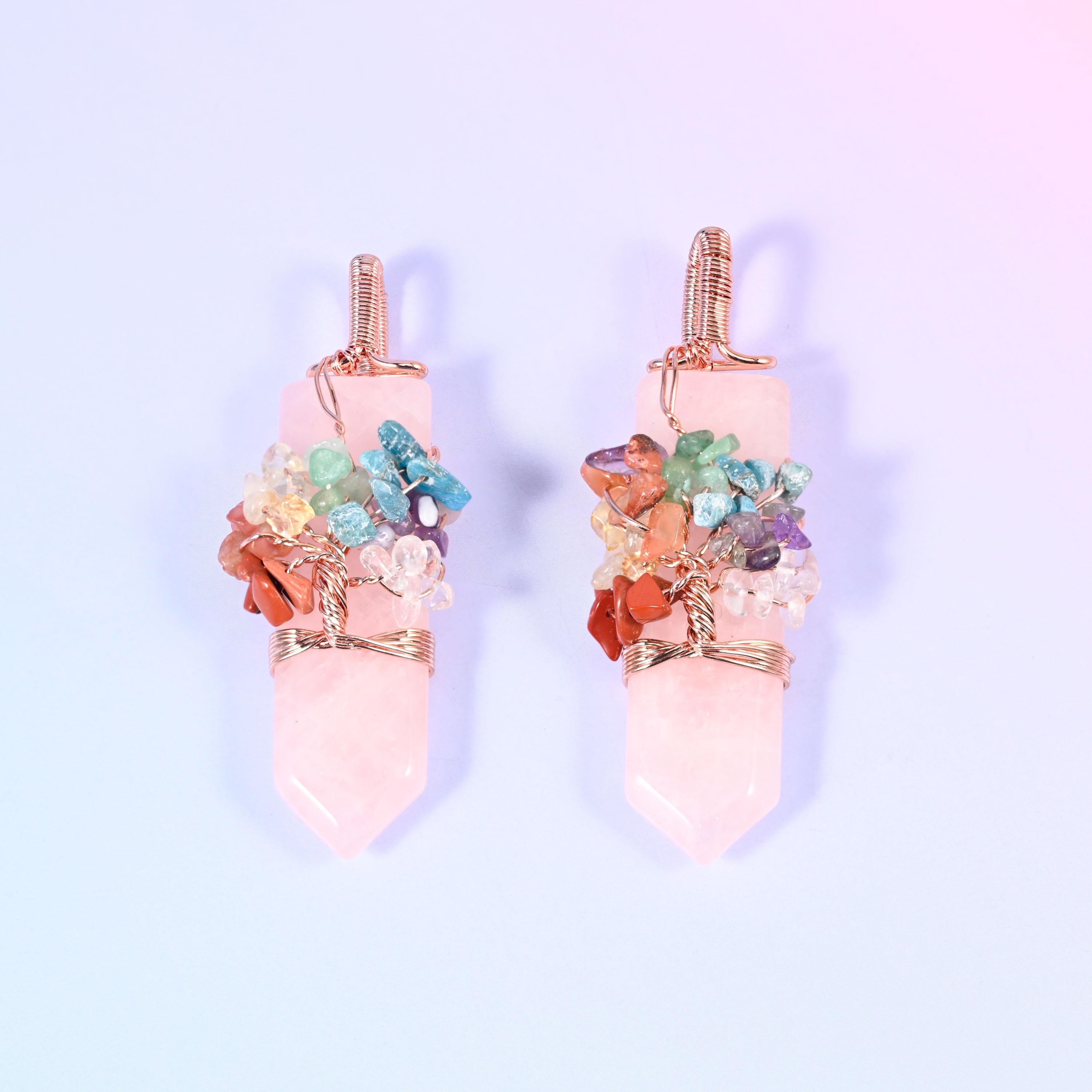 A polished single-point hexagon stone with a copper wire tree worked over the shoulder, set with small multi-colour gemstone chips