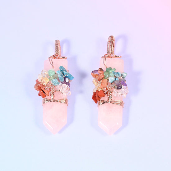 A polished single-point hexagon stone with a copper wire tree worked over the shoulder, set with small multi-colour gemstone chips