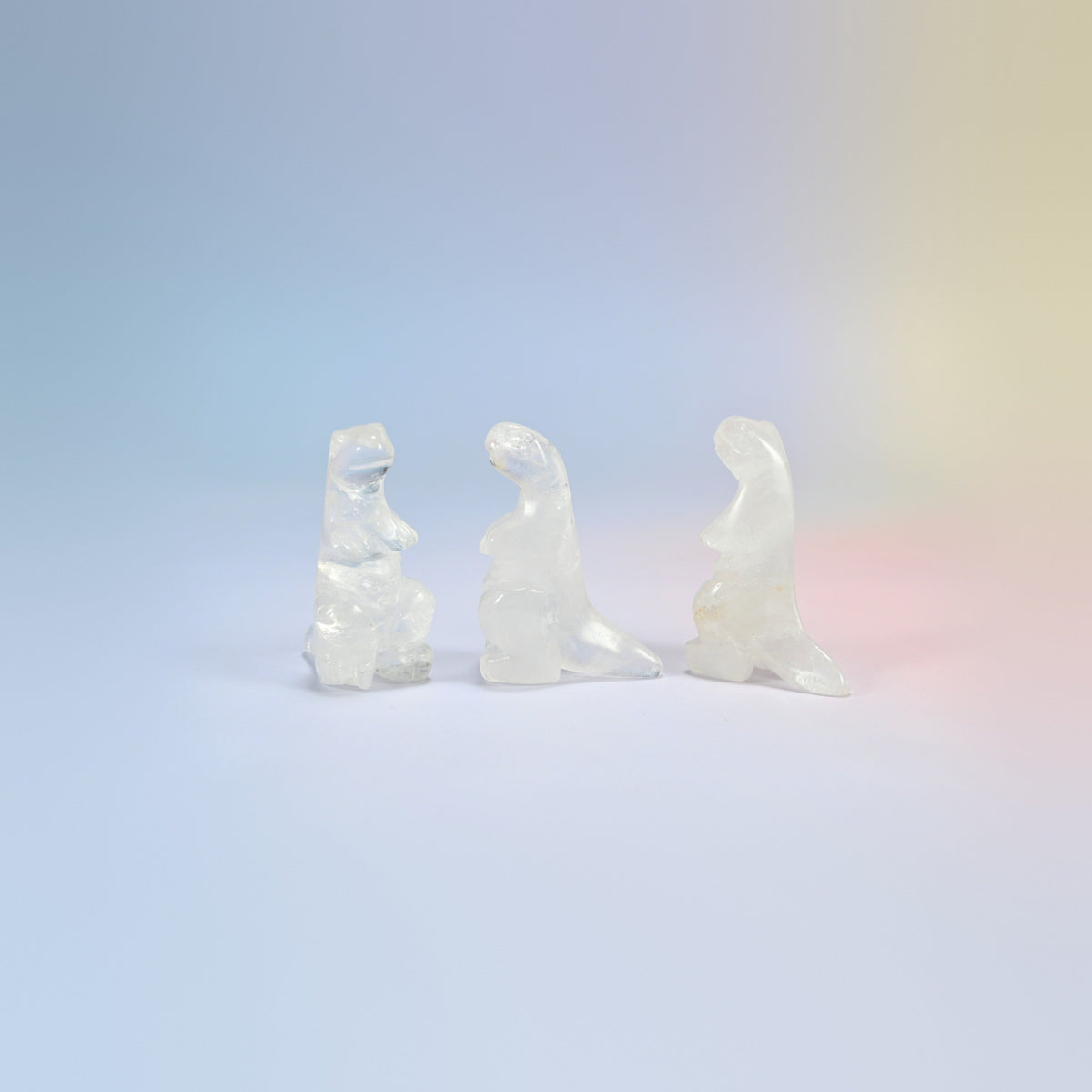 Three clear quartz T-Rex dinosaur crystal carvings, 2 inch, milky clear natural stone