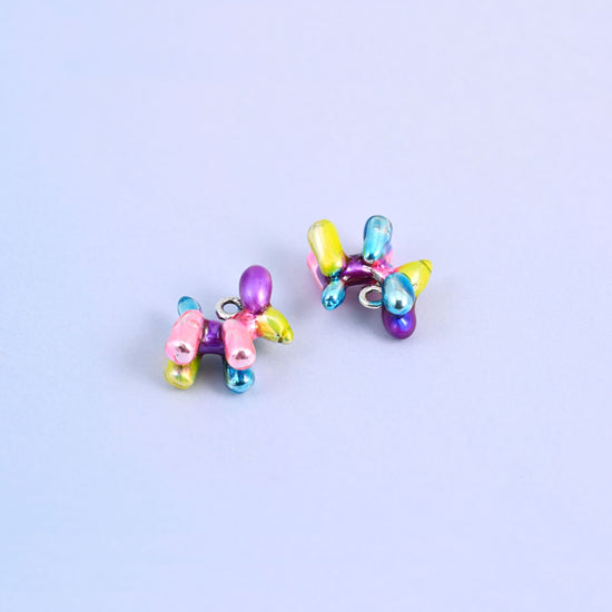 Balloon dog charms lying on their sides, 14.53 x 14.41mm with a small ring behind the neck.