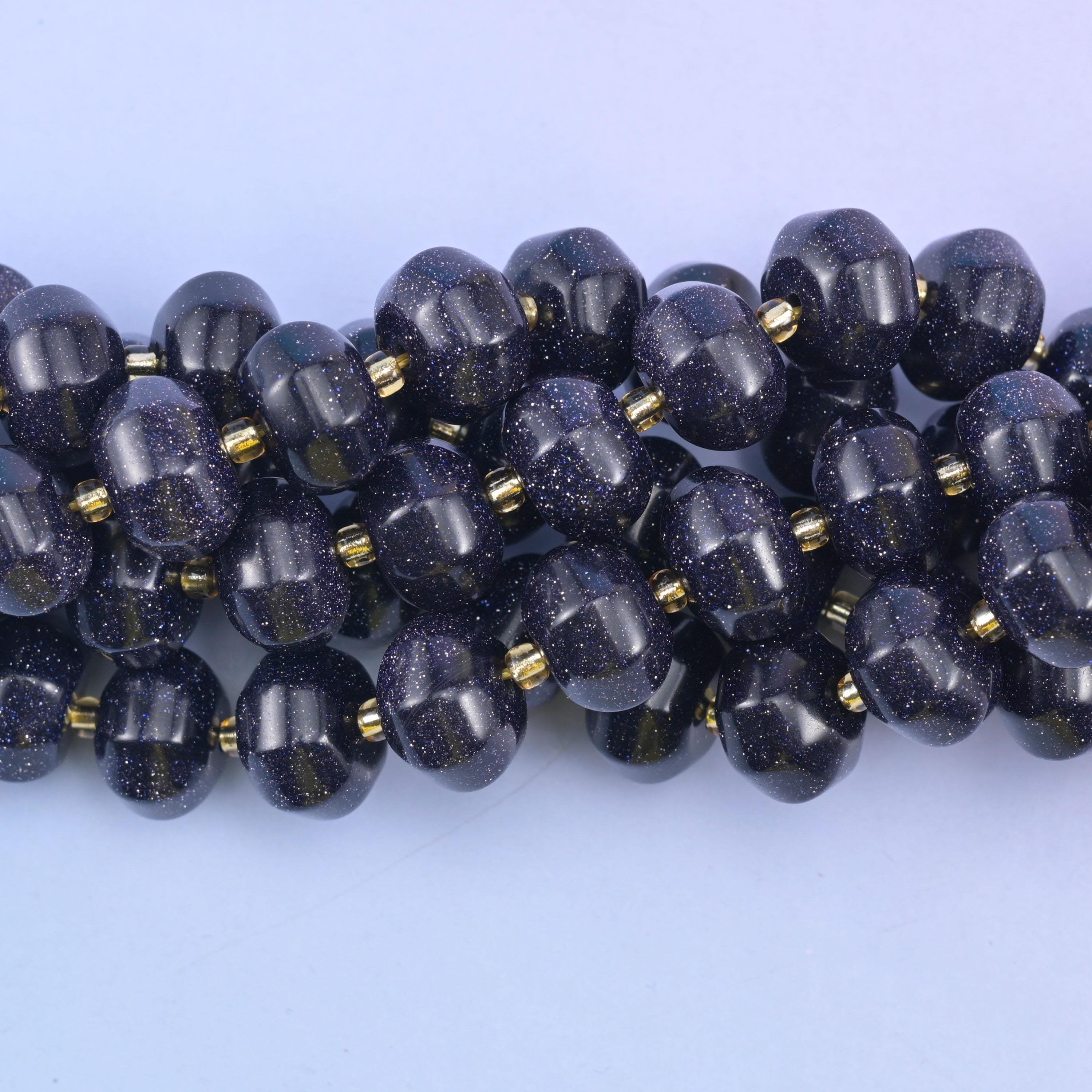 Close view of grooved Blue Sandstone pumpkin beads showing copper glitter flecks