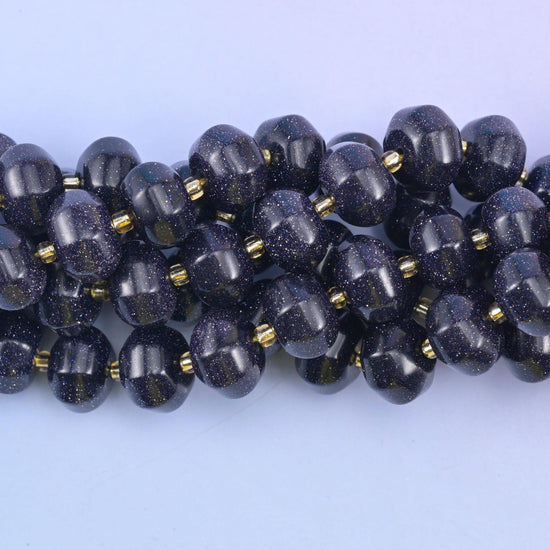 Close view of grooved Blue Sandstone pumpkin beads showing copper glitter flecks
