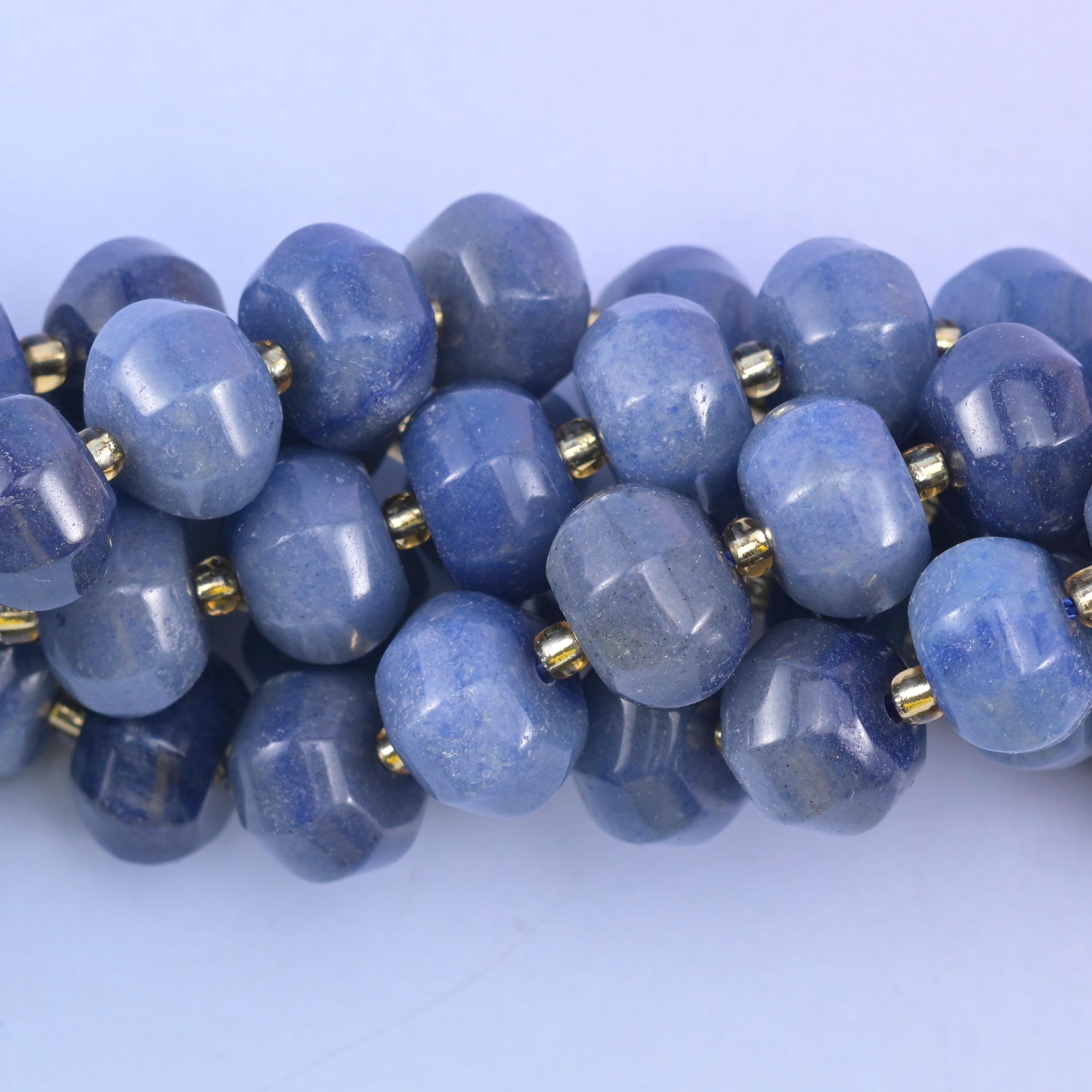 Macro frame of a few beads, catching the fine silvery glitter and pale streaking inside the blue stone