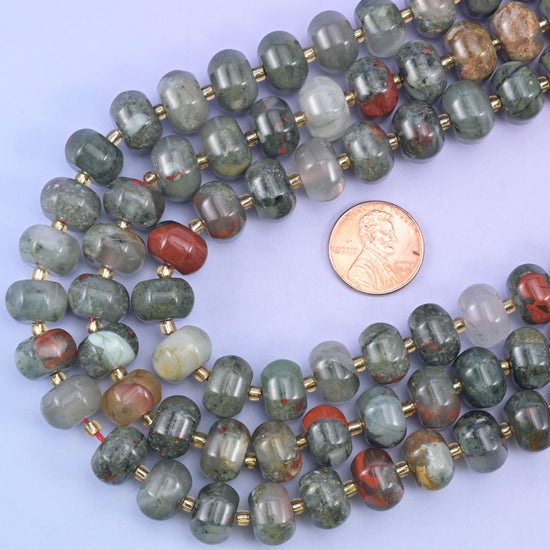 Pumpkin rondelle strands looped around a US penny to show the 12x8mm bead scale
