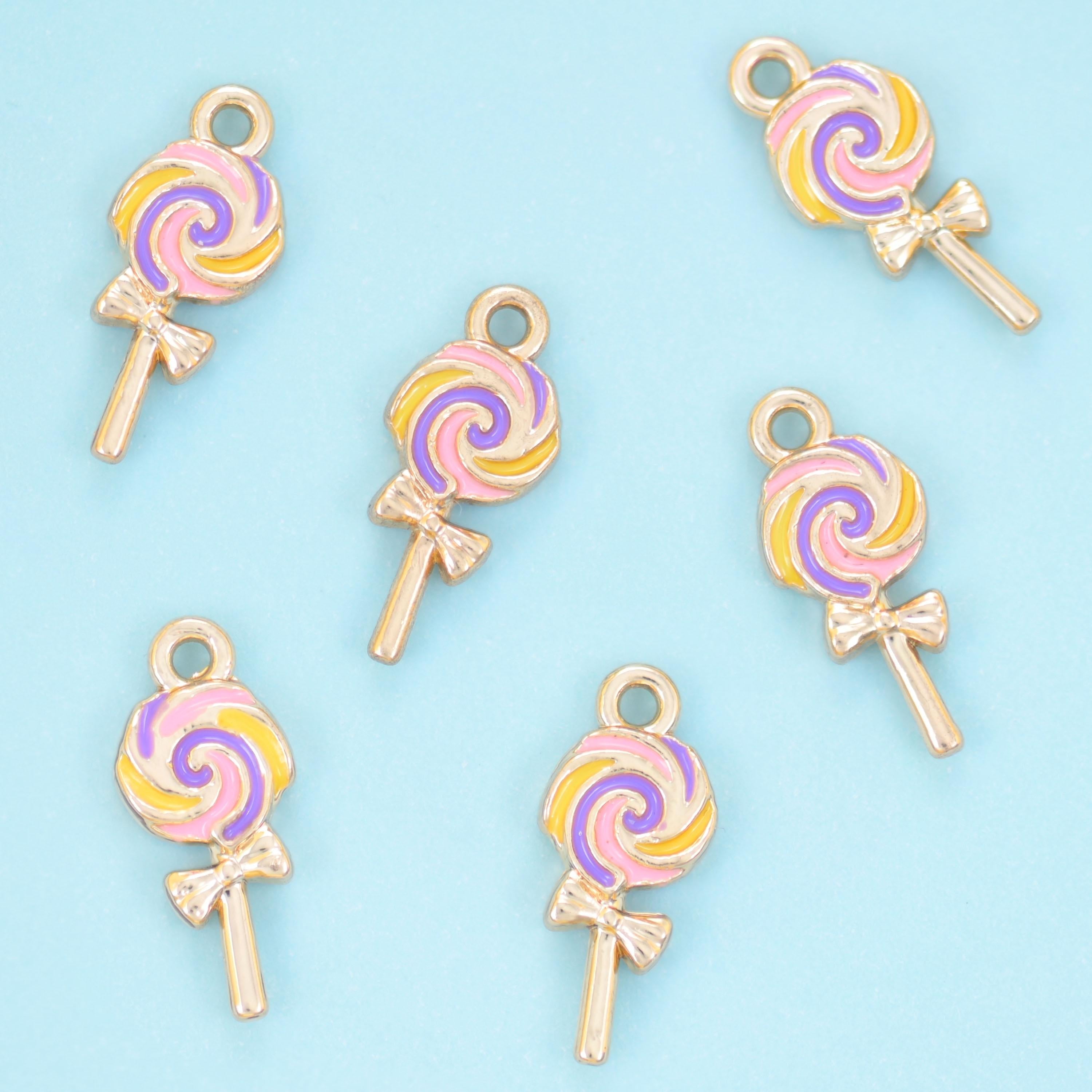A flat little lollipop with the candy swirl painted in pastel enamel between fine gold lines — soft pink, buttercream,…