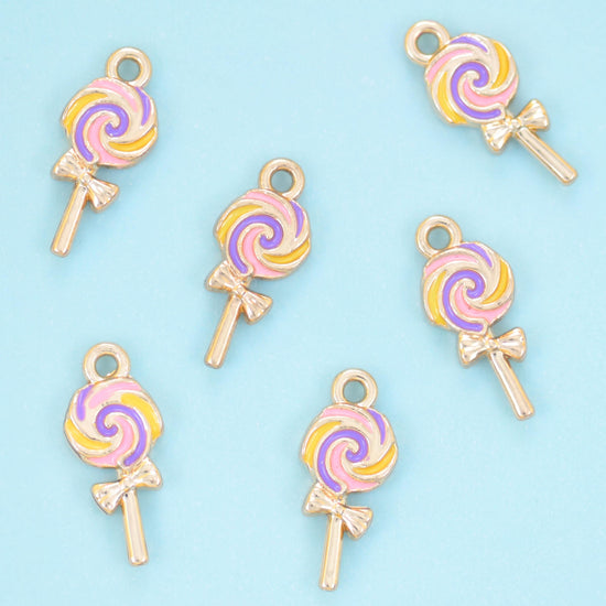 A flat little lollipop with the candy swirl painted in pastel enamel between fine gold lines — soft pink, buttercream,…