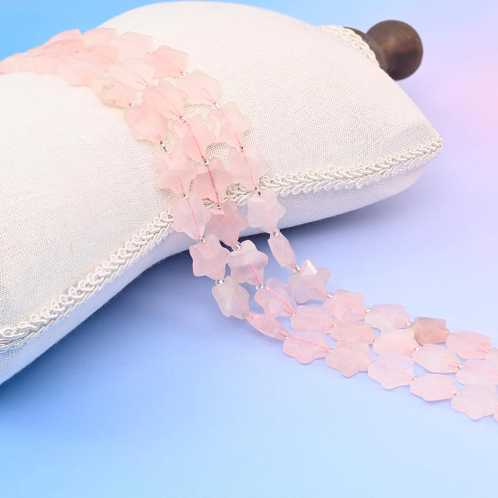 Rose Quartz 5 Pointed Faceted Star Beads in pale blush, milky translucence.
