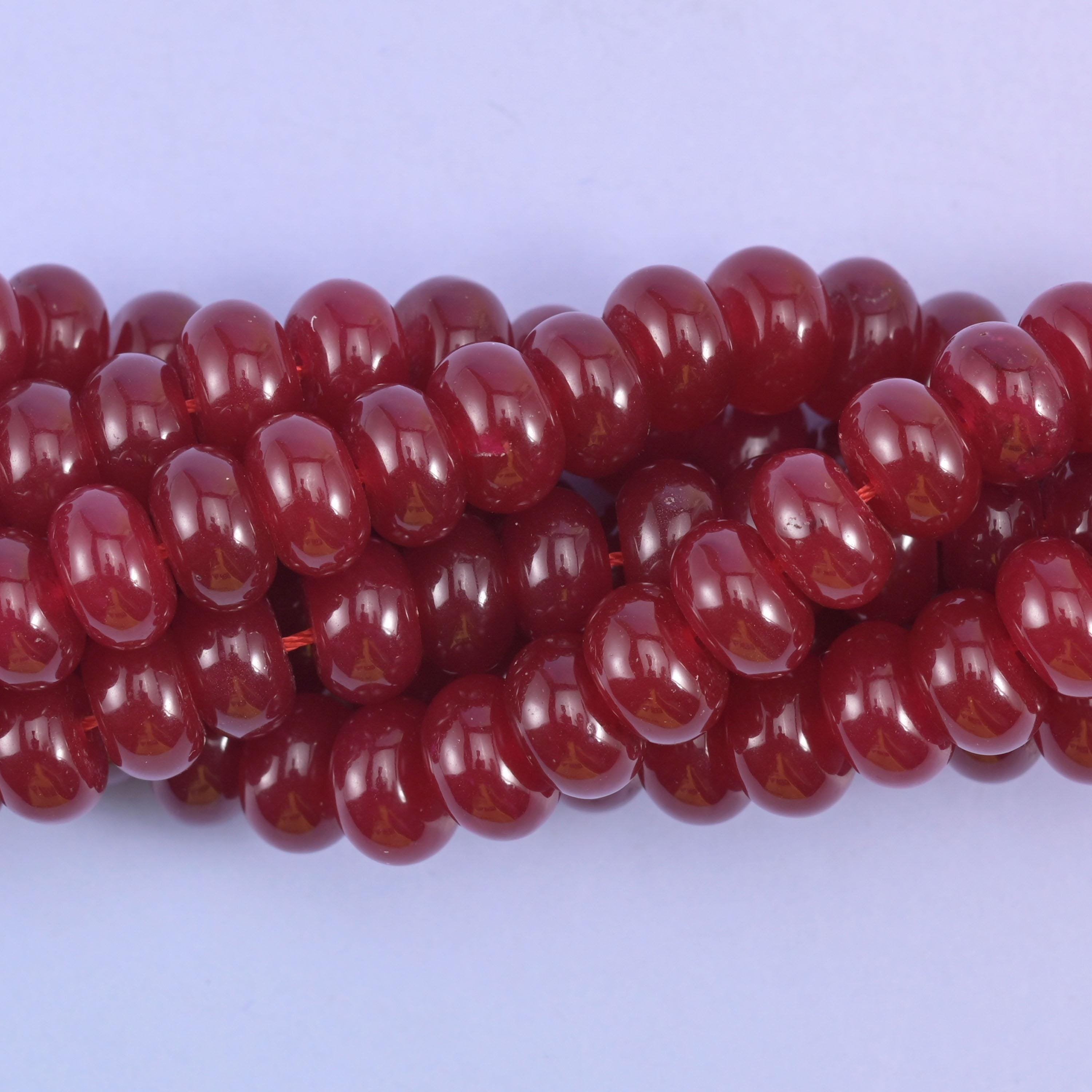 Smooth rondelle cut dyed jade beads with a polished surface