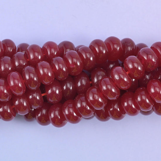 Smooth rondelle cut dyed jade beads with a polished surface