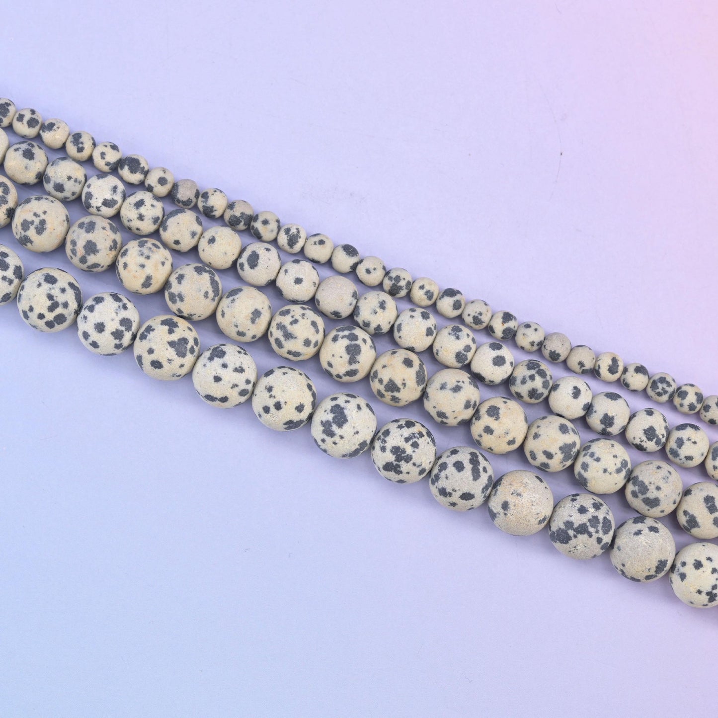 Dalmatian Jasper beads, each bead reading a little differently in its spotting