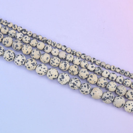 Dalmatian Jasper beads, each bead reading a little differently in its spotting