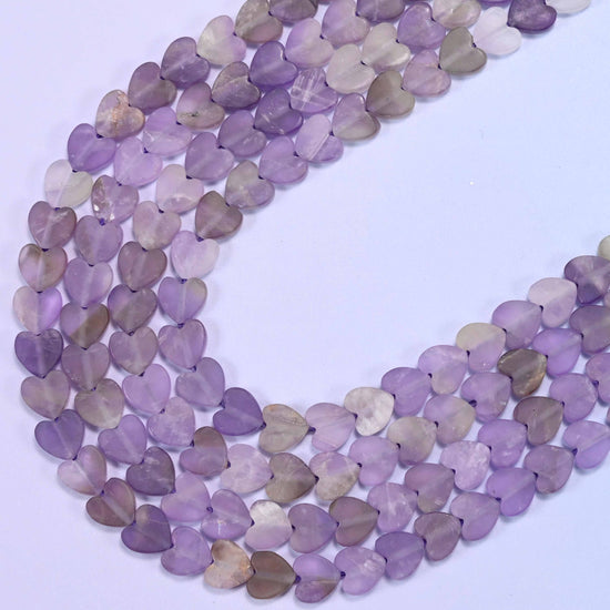 Amethyst beads coiled to show consistent flat heart-shaped bead size and drilled holes